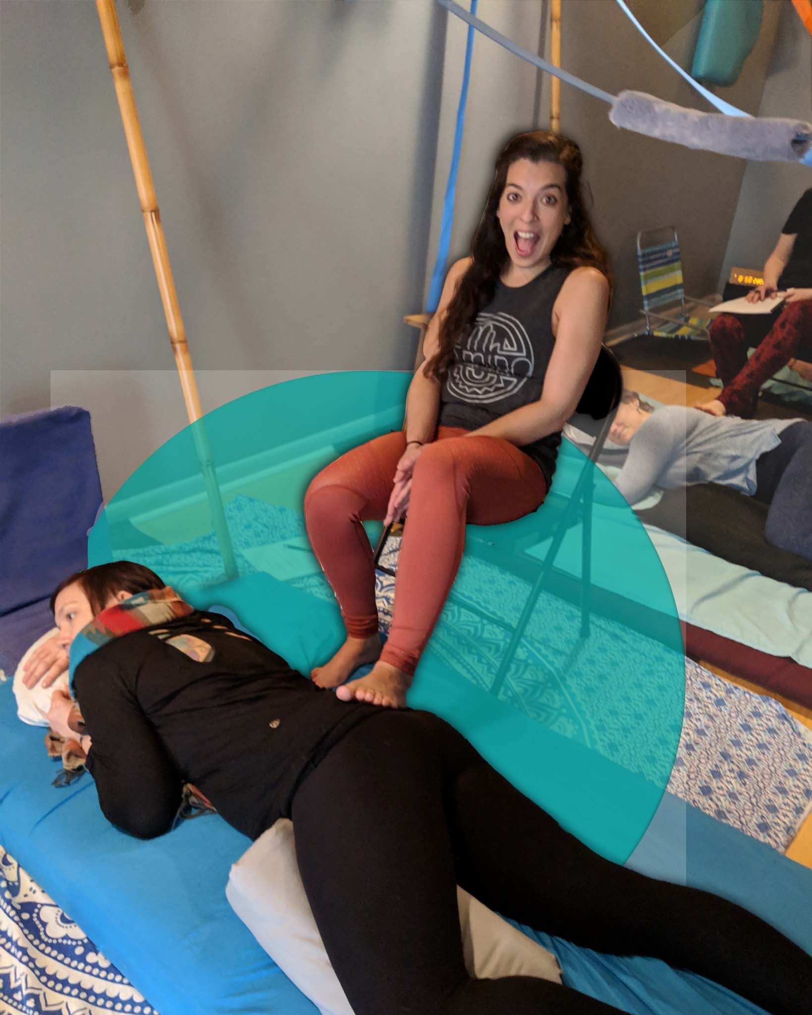 Fijian massage in action - the LMT is sitting on a chair working on the clients lumbosacral area. Learn this in Barefoot Matwork, one of our beginner barefoot massage classes
